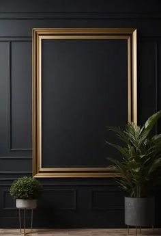 an empty gold frame on a black wall next to two potted plants