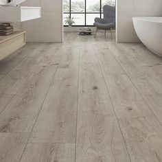 a bathroom with white walls and wood flooring on the floors, along with a bathtub