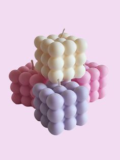 three balloons are stacked on top of each other in the shape of a bunch of grapes