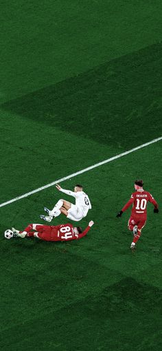 two soccer players colliding on the field during a game with one falling to the ground