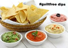 chips and dips in small bowls on a white table