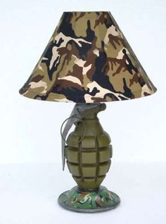 a lamp that is sitting on top of a white surface with a camouflage print shade