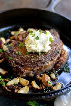 steak with potatoes and parsley in a cast iron skillet