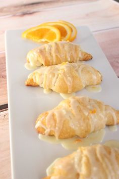 orange brunch crescents are lined up on a white plate