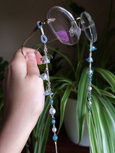 Introducing a glasses chain inspired by the enchanting bluebell flowers. This delicate piece features intricate flower beads, complemented by soothing aquamarine beads and imitation pearls. Designed to add a touch of femininity to your eyewear, this chain is as elegant as it is functional. Elevate your accessory game with this enchanting wisteria-inspired glasses chain. This eyeglass chain might be slightly heavier than regular chains because of some stone beads and crystals. Actual colors of an Cheap Glasses Chains With Colorful Round Beads, Glasses Accessories Jewelry, Chains For Glasses, Cute Glasses Chain, Blue Beaded Glass Glasses Chains, Whimsical Adjustable Beaded Chain Jewelry, Handmade Adjustable Blue Glasses Chains, Handmade Blue Glass Glasses Chains, Elegant Adjustable Blue Glasses Chains