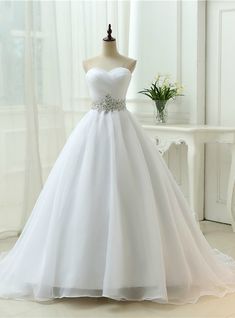 a white wedding dress on a mannequin