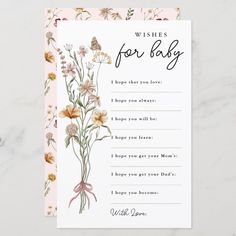 a baby shower wish card with flowers on it