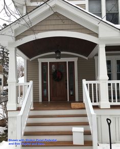 the front porch is decorated with wreaths and christmas wreaths on the door post