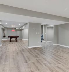 an empty room with a pool table in it