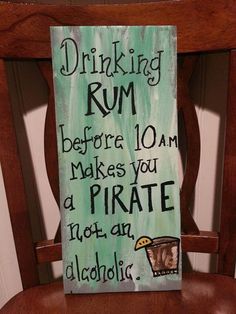 a wooden chair with a sign on the back of it that says drinking rum before you make