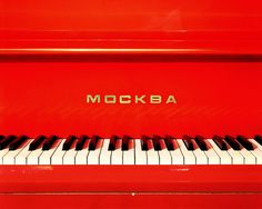 a red piano with the word mockba written on it's front side