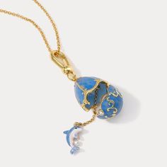 Dive into ocean wave with our Dolphin Egg Locket Necklace! 🐬 This enchanting piece features a playful dolphin embracing a delicate egg locket, creating a cute and endearing design. Perfect for ocean lovers, this necklace adds a touch of charm and marine magic to your style. Express your love for these intelligent creatures and make a splash with this delightful accessory! DETAILS Plating: 18K Gold Materials: 18K Gold on Brass, Enamel Measurements: Length:  24.80 "(63cm)  + Extender: 2.36"(6cm) Egg Necklace, I Love Gold, Dolphin Jewelry, Ocean Necklace, Pearl Gifts, Fish Necklace, Ocean Jewelry, Enamel Necklaces, Disney Jewelry