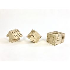 three pieces of concrete sitting next to each other on a white surface with one piece missing