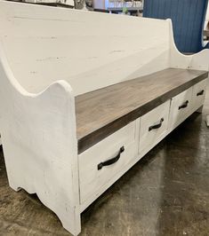 a white bench with two drawers underneath it