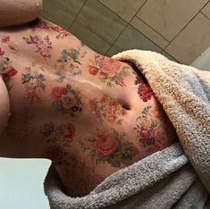 a man with flowers on his back under a towel