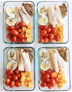 four glass containers filled with different types of food including tomatoes, cheese and crackers