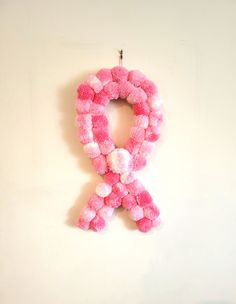 a pink ribbon is hanging on the wall