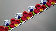 a close up of an embroidered ribbon with flowers on it