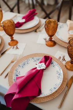 a table set with place settings and napkins