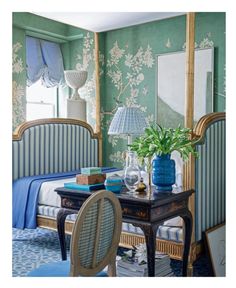 a bedroom with green walls and blue furniture