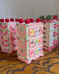 three decorated chests with cherries on them