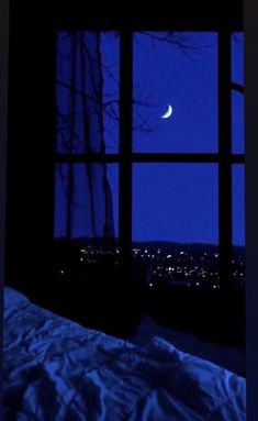 the moon is seen through an open window