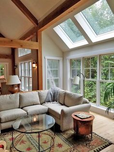 a living room filled with furniture and a fire place in the middle of a room