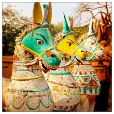 three colorfully painted animal heads sitting next to each other