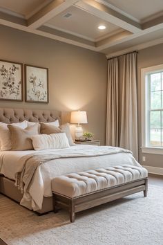 a bedroom with a large bed and two paintings on the wall