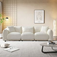 a living room with a white couch and coffee table