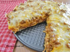 a cheesy pizza on a pan with one slice cut out and ready to be eaten