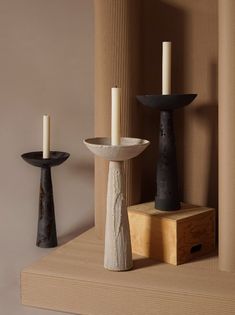 ALT= A row of three ceramic candlesticks holding white church candles with burnt wicks. On the left is a black and copper candlestick, the middle a soft grey, and the right, black. They have been photographed amongst packaging materials. Pottery Candle Sticks, Ceramic Candle Stick, Cycladic Art, The Wicker Man, Lucie Rie, Japandi Interior Design, Karl Blossfeldt, Wicker Man, Queen Of Scots