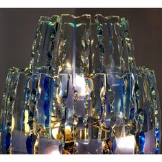 a glass chandelier with blue and green beads