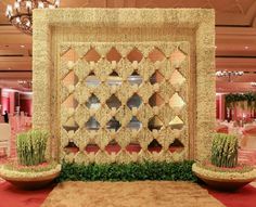 an elaborately designed display in the middle of a room with red carpet and chandelier