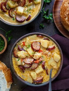 two bowls filled with soup next to bread