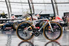 a bike parked in front of a racing car