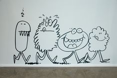 three cartoon characters are drawn on the wall