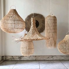 several woven baskets hanging from the ceiling