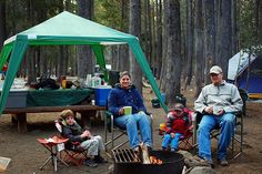 a group of people sitting around a campfire