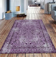 a large purple rug is in the middle of a wood floored hallway with blue walls