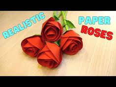 three red roses sitting on top of a table next to the words realistic paper roses