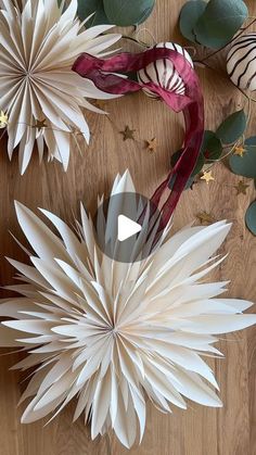 paper flowers are arranged on a wooden table