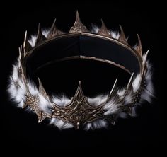 a crown with white feathers on it