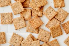 some crackers are laying on top of each other and scattered around the table,