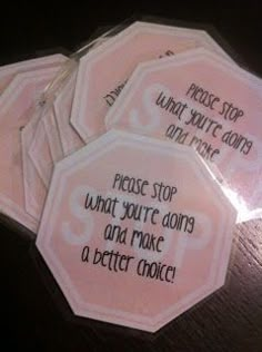 four pink tags with words on them that say stop what you're doing, walk over and hand this to a child instead of yelling