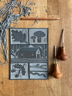 an image of some art work on a wooden table with paintbrushes and pencils