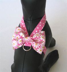 a dog wearing a pink and white flowered bow tie on it's collar