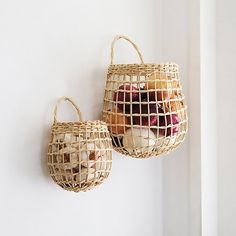 two woven baskets hanging on the wall