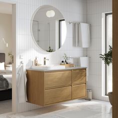 a bathroom with a sink, mirror and bathtub in it's center area