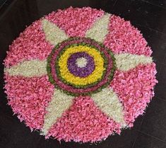 a pink, yellow and white flower arrangement on the floor